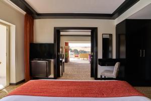 a bedroom with a bed and a flat screen tv at Mövenpick Resort Aswan in Aswan