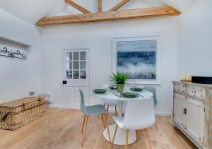 a dining room with a white table and chairs at Spring House Studio in Alderton