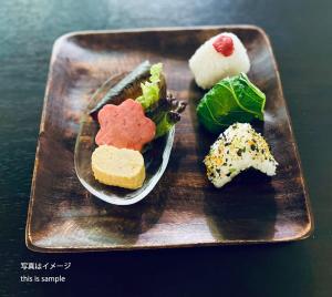 um prato com três tipos diferentes de alimentos nele em bHOTEL Komachi - Apt for 6ppl few mins walk to Peace Park em Hiroshima