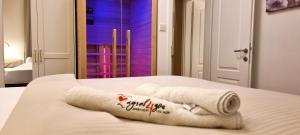 a towel on a bed in a room at Zagreb4you Apartments - Family paradise with sauna in Zagreb