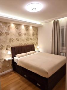 a bedroom with a large bed in a room at Zagreb4you Apartments - Family paradise with sauna in Zagreb