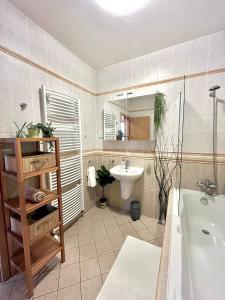 a bathroom with a tub and a sink and a toilet at Apartment Tina - Old Town, Free Private Parking in Bratislava