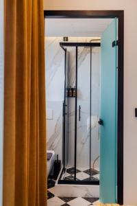a bathroom with a shower with a yellow curtain at Aggelos Hotel in Alexandroupoli