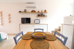 a wooden table with a bowl on top of it at Malikas House Otranto in Otranto