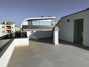 a balcony of a building with a walkway on it at Brand New 2 Bed, 1 Bath Condo in Zadar
