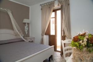 a bedroom with a bed with a flower arrangement on it at Casa Lu Duttori in Arzachena