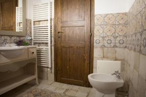 a bathroom with a toilet and a sink at Casa Lu Duttori in Arzachena