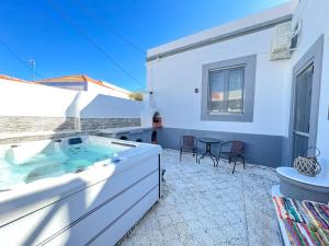 a hot tub in the backyard of a house at La Casa di villagio in Koskinou