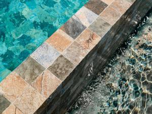 a close up of a pool with a tiled floor and water at ibis La Ciotat in La Ciotat