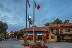 a hotel with flags in front of a building at Best Western Americana Inn in San Ysidro
