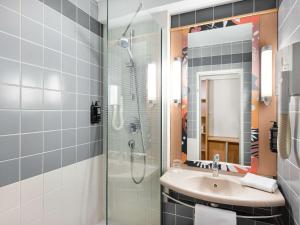 a bathroom with a sink and a shower at Ibis Budapest Heroes Square in Budapest