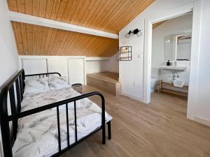 a bedroom with a bunk bed and a bathroom at Picú Home in Málaga