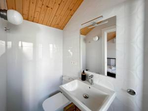 a white bathroom with a sink and a mirror at Picú Home in Málaga +116 photos