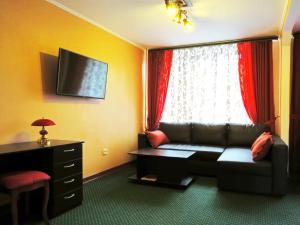 a living room with a couch and a window at Hotel Jubilee in Obninsk