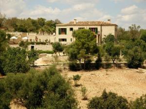 a house in the middle of a field with trees at Villa Son March casa con piscina en Petra in Petra