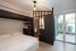 a bedroom with a bunk bed and a large window at BEACH HOUSE in Les Grenettes