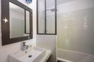 a bathroom with a sink and a mirror and a tub at BEACH HOUSE in Les Grenettes +15 photos