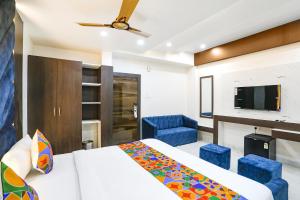 a hotel room with a bed and a tv at FabHotel Prime SM Resort in Bhopal