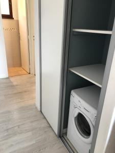 a laundry room with a washer and dryer at Location corsica in Ajaccio