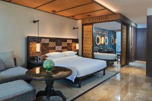 a bedroom with a bed and a bathroom with a tub at Andaz Bali - a Concept by Hyatt in Sanur