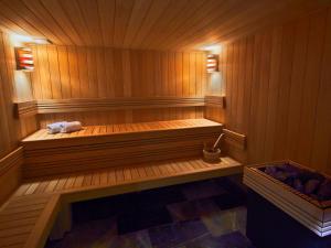 una sauna in legno con un asciugamano seduto in esso di La Licorne Hotel & Spa Troyes MGallery a Troyes