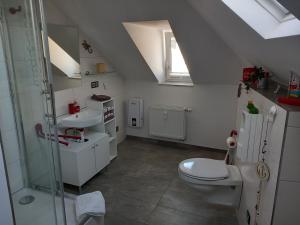 a bathroom with a toilet and a sink at Ferienwohnung im roten Haus in Bad Ems