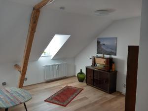 a living room with a wooden floor and a window at Ferienwohnung im roten Haus in Bad Ems