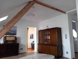 an attic room with a large wooden beam at Ferienwohnung im roten Haus in Bad Ems