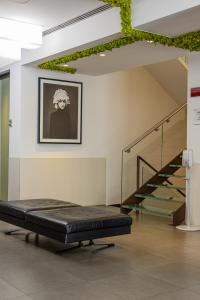 a bed in a room with a stair case at Best Western Plus Hotel De Capuleti in Verona