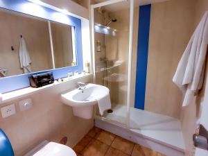 a bathroom with a sink and a toilet and a shower at greet Hotel Belleville en Beaujolais A6 in Belleville-sur-Saône