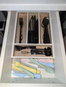 a white drawer filled with utensils and utensilsktop at Konnet Apartment in Rhodes Town