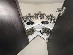 a stove with pots and pans on top of it at Konnet Apartment in Rhodes Town