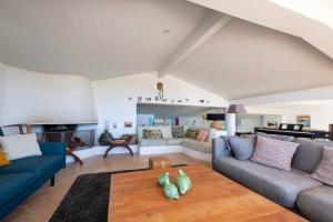 a living room with a couch and a table at Maison de famille donnant sur le Golf et le Fier d'Ars dans un parc de 7500m2 in Les Portes