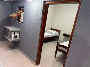 a mirror in a room with a small bedroom at Hotel Lara's in Ribeirão Preto +24 photos