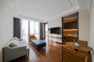 a living room with a couch and a table at UrCove by Hyatt Shanghai Pudong East in Shanghai