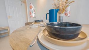 a bowl sitting on a plate on a table at Burlington Mansions - Stunning Coastal Apartment in Bournemouth +21 photos
