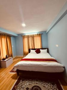 a bedroom with a large bed with blue walls at PS Boutique Hotel in Kathmandu