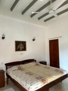 a bedroom with a large bed with a ceiling at Village Inn Resort in Negombo