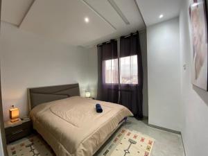 ein kleines Schlafzimmer mit einem Bett und einem Fenster in der Unterkunft chez vicky in Tunis