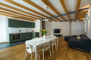 a kitchen and living room with a white table and chairs at Casa Corradini by Go New Location in Carano