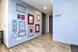 a hallway with framed pictures on a wall at Townhouse RCC PARK VIEW INN in Hyderabad