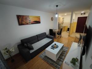 a living room with a couch and a table at Apartman Centar in Doboj