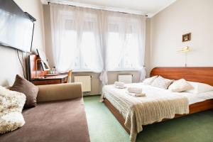 Postel nebo postele na pokoji v ubytování Pod Ratuszem + 37 fotografií