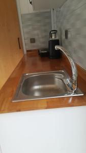 a kitchen sink with a faucet on a counter at ROTA OLYMPOS TİNY HOUSE in Kumluca
