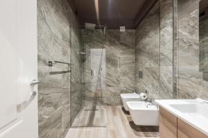 a bathroom with a shower and a sink and a toilet at Relax Inn Hotel Durres in Durrës