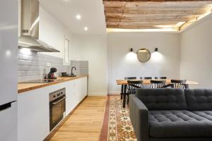 a kitchen and living room with a couch and a table at Comfortable apartment next to Apolo theater in Barcelona