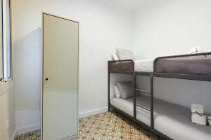 a bedroom with a mirror and a bunk bed at Comfortable apartment next to Apolo theater in Barcelona