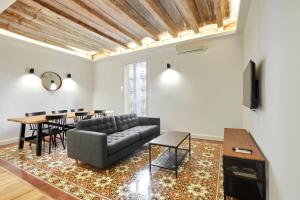 a living room with a couch and a table at Comfortable apartment next to Apolo theater in Barcelona