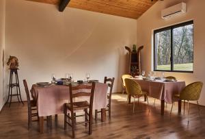 a dining room with two tables and chairs and a window at Agriturismo Prato del Re in Prignano sulla Secchia