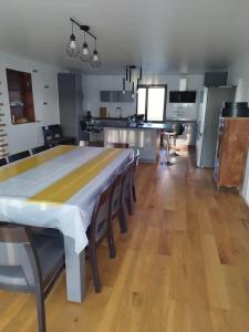 a kitchen and dining room with a table and chairs at Belle maison de Campagne Confortable avec piscine, pétanque etc 17 couchages in La Bazoche-Gouet +15 photos